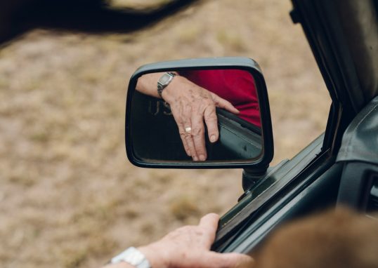 person holding car door