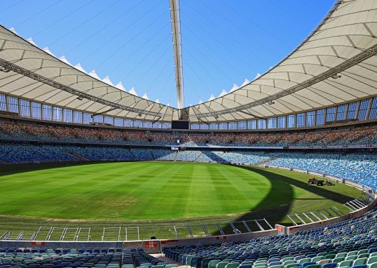 a large stadium filled with lots of blue seats